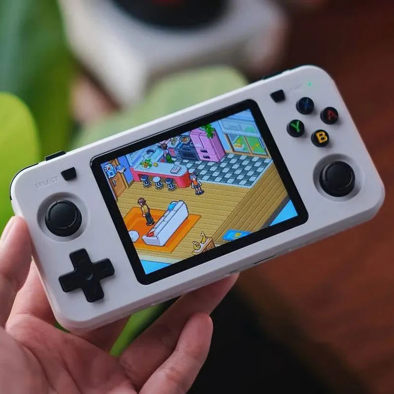 R36H Handheld gaming console with a colorful game displayed on the screen, held by a person.